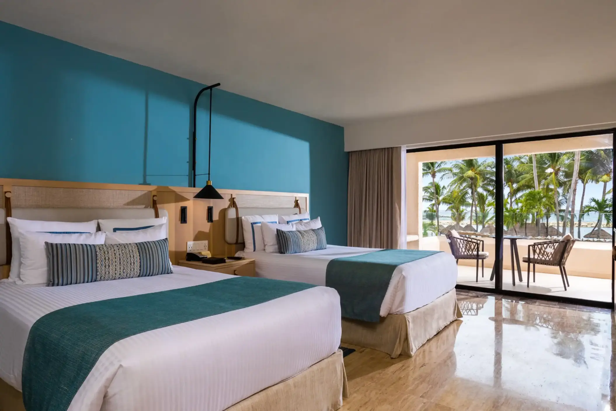 Double deluxe room with vibrant pool view, accented with airy interiors and tropical charm.