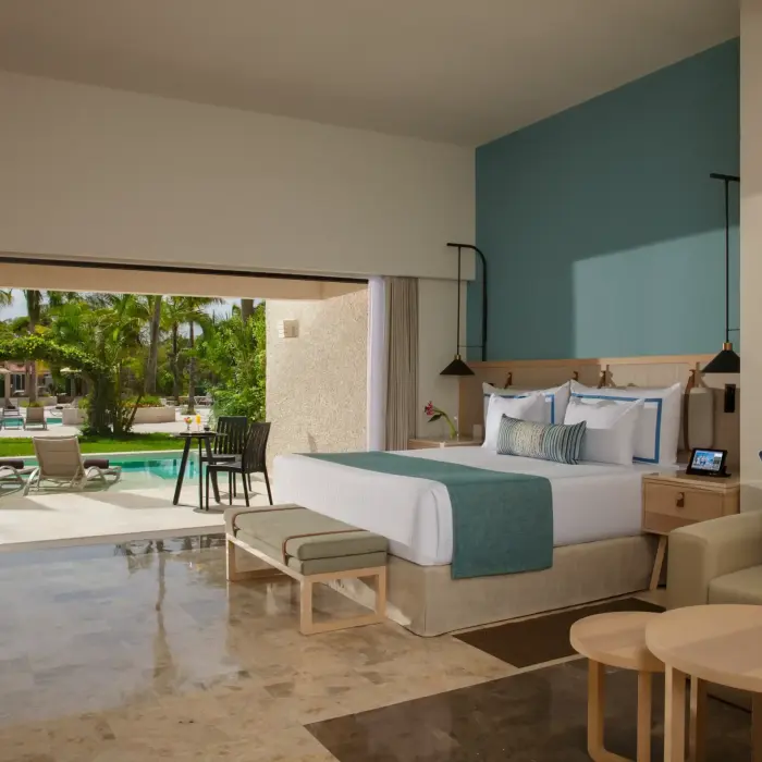 Luxury swim-up suite at Dreams Aventuras with modern decor, private pool access, and tropical garden views.