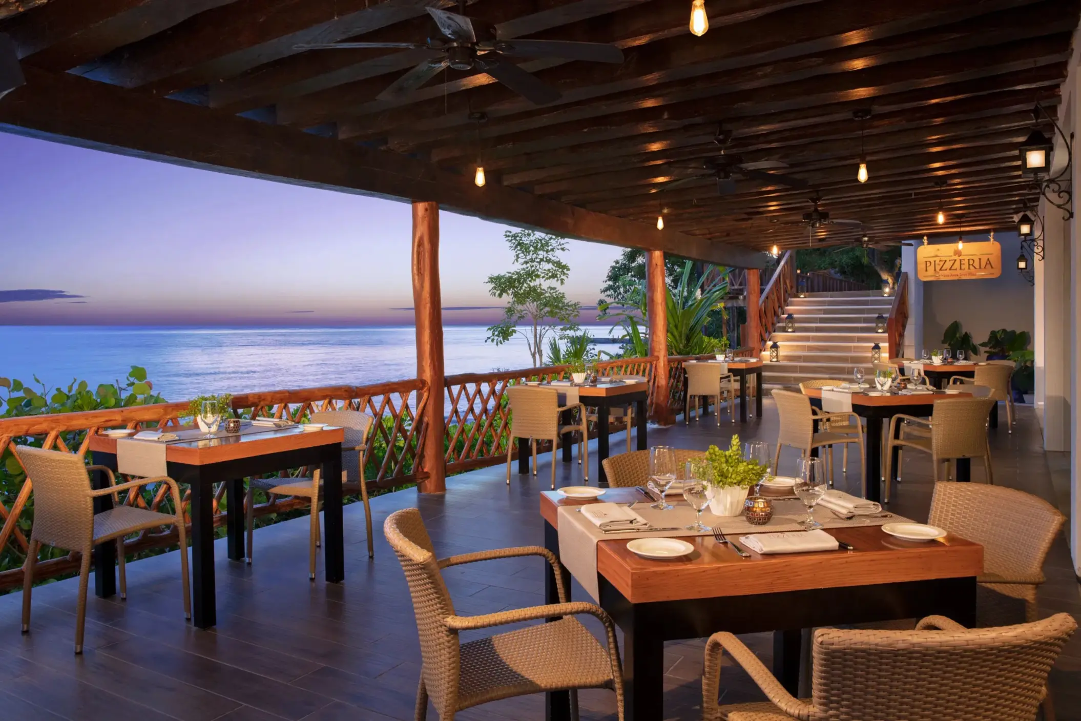 Cozy outdoor seating at the resort’s ocean-view pizzeria, perfect for evening dining with rustic charm.