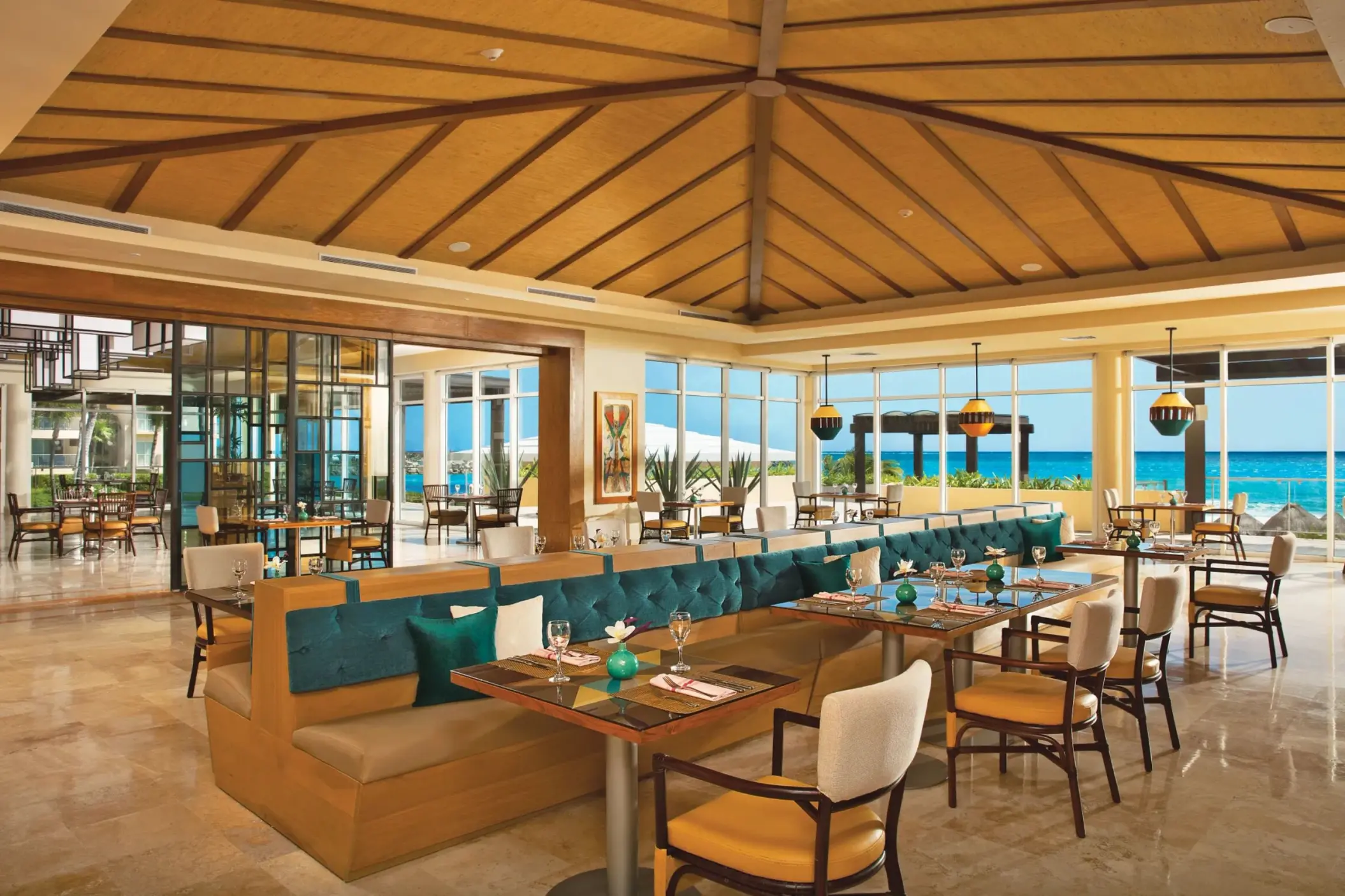 Spacious dining area at Carnival Café with vibrant décor, ocean views, and elegant table settings for casual meals.