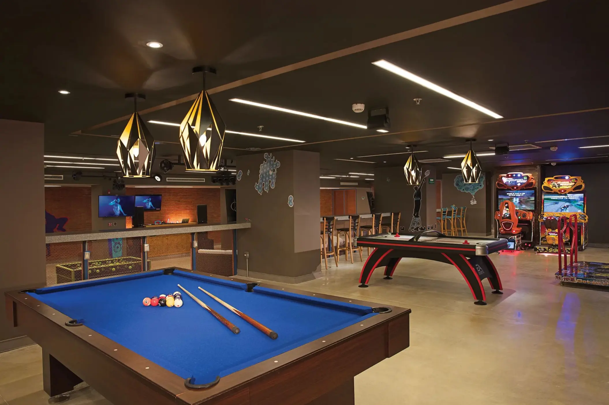 Core Zone teen club with pool table, air hockey, arcade games, and stylish modern lighting fixtures.