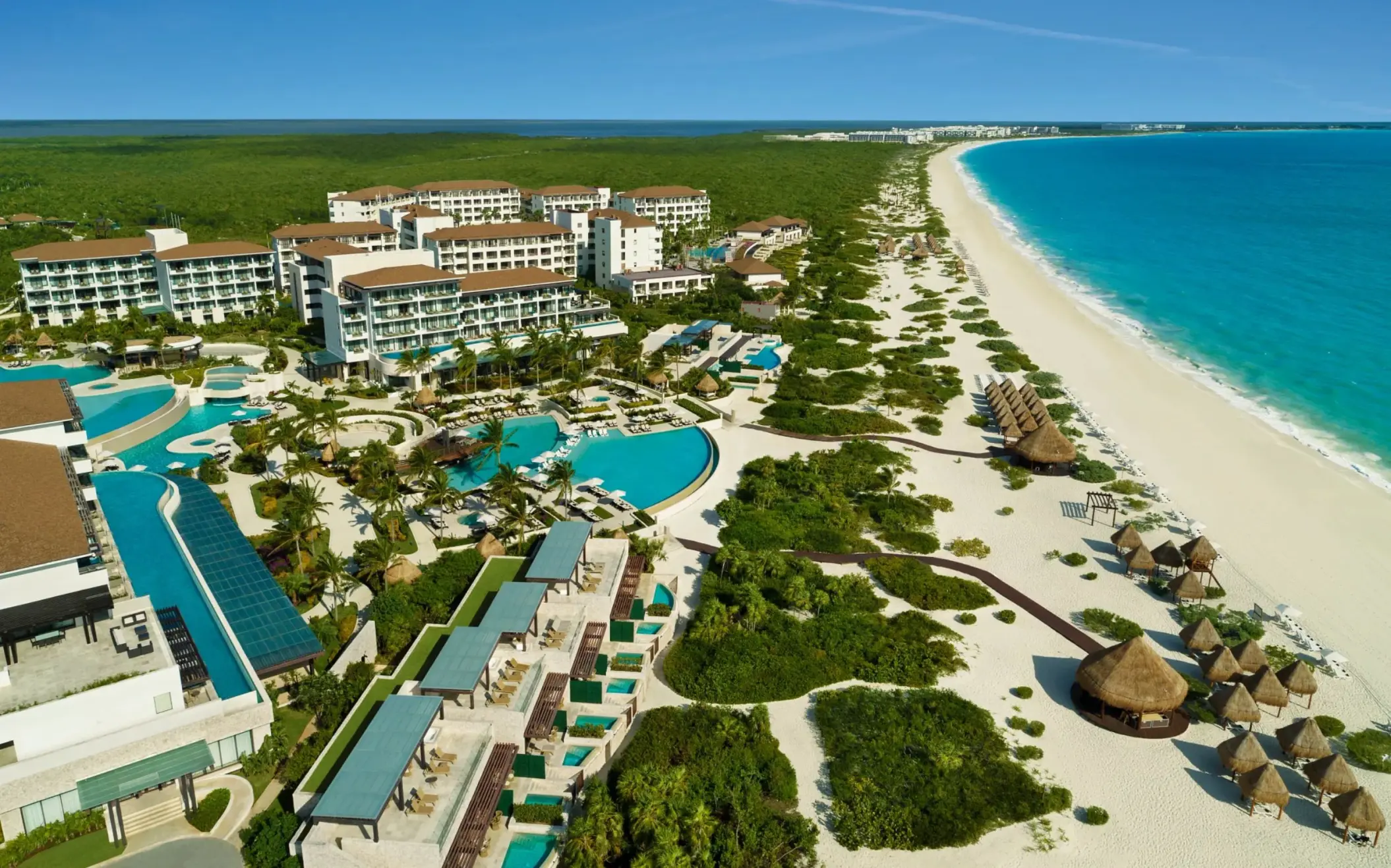 Dreams Playa Mujeres Resort aerial showing pools, oceanfront, and tropical landscape from above.
