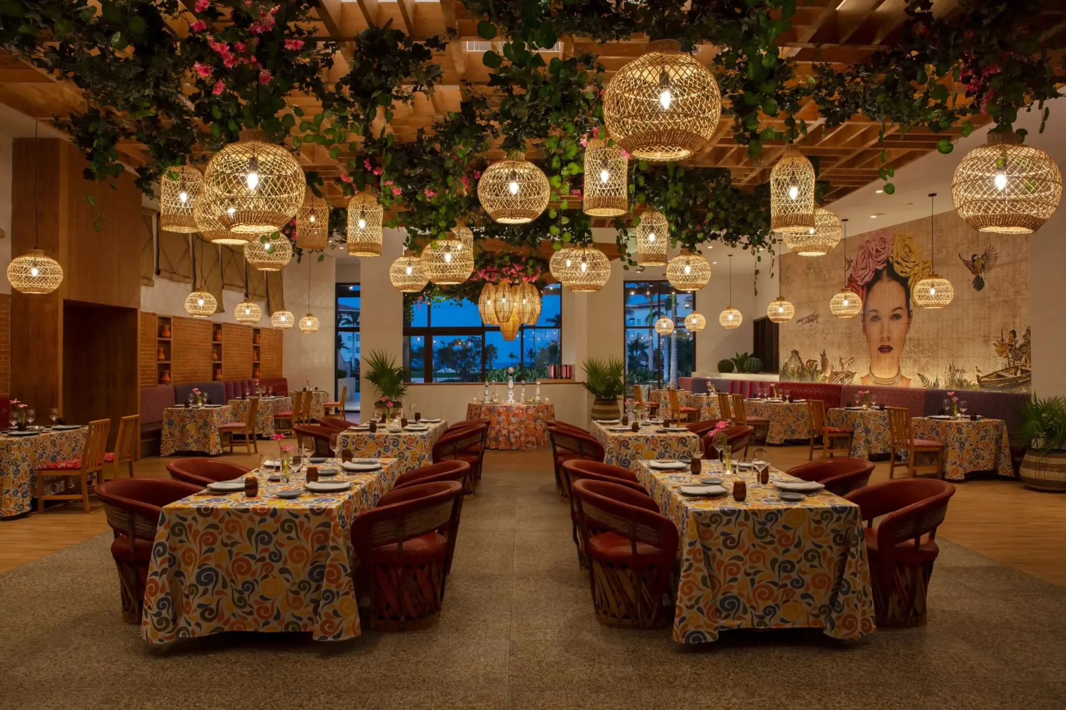 Tres Colores restaurant boasts vibrant Mexican decor, hanging lanterns, and colorful mural-inspired artwork.