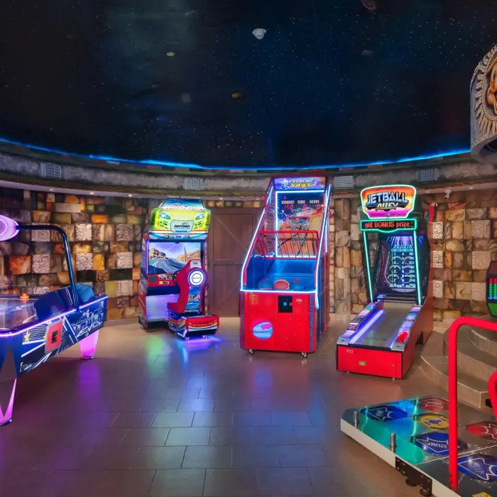 Fully equipped indoor arcade with video games and air hockey table at Dreams Riviera Cancun Explorer’s Club