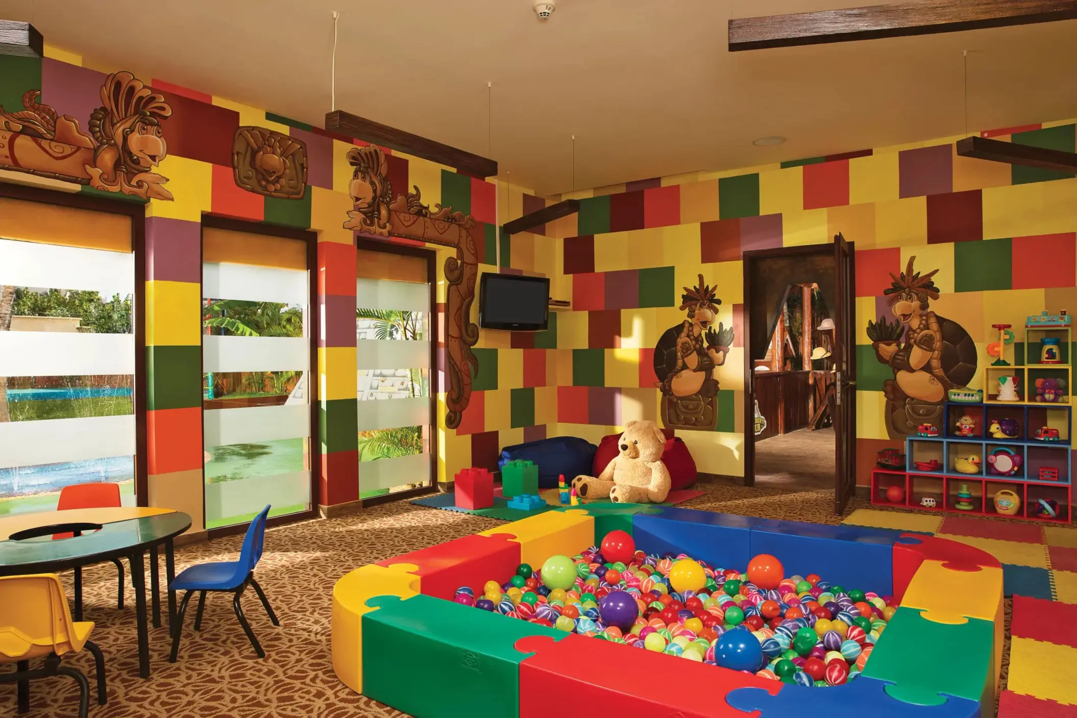Colorful toddler play area with ball pit, wall art, and toys at Dreams Riviera Cancun Explorer’s Club