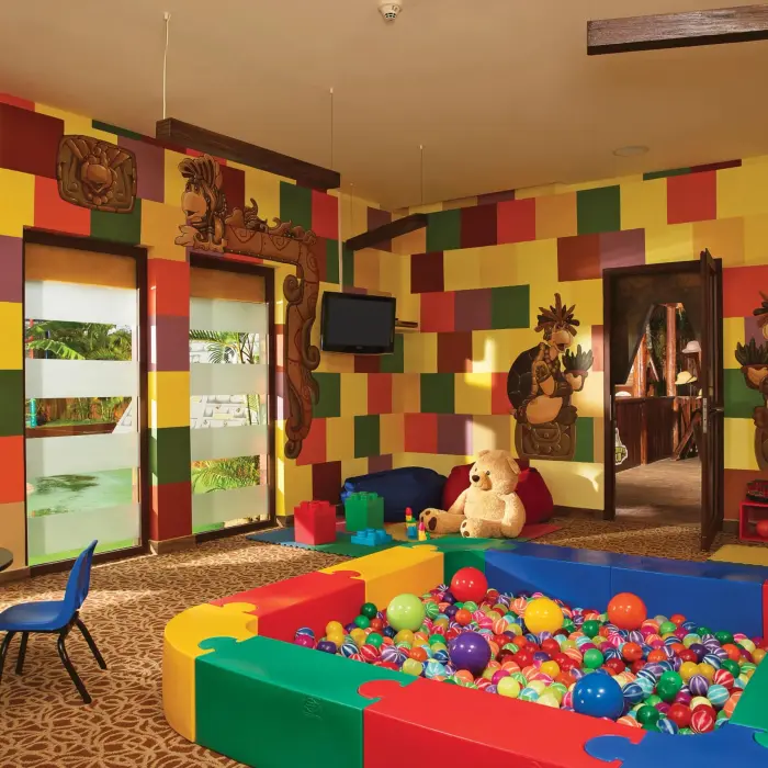 Colorful toddler play area with ball pit, wall art, and toys at Dreams Riviera Cancun Explorer’s Club