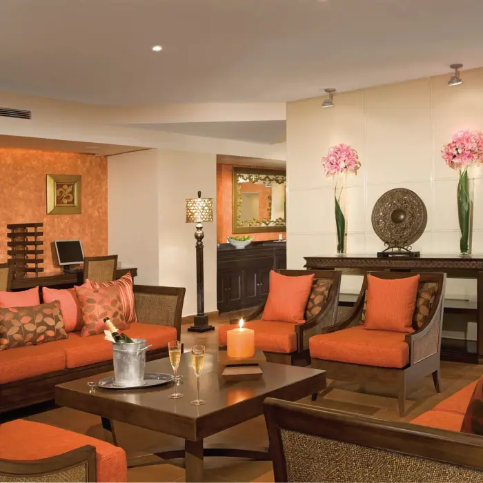Preferred Club lounge interior with plush orange seating and a cozy ambiance.