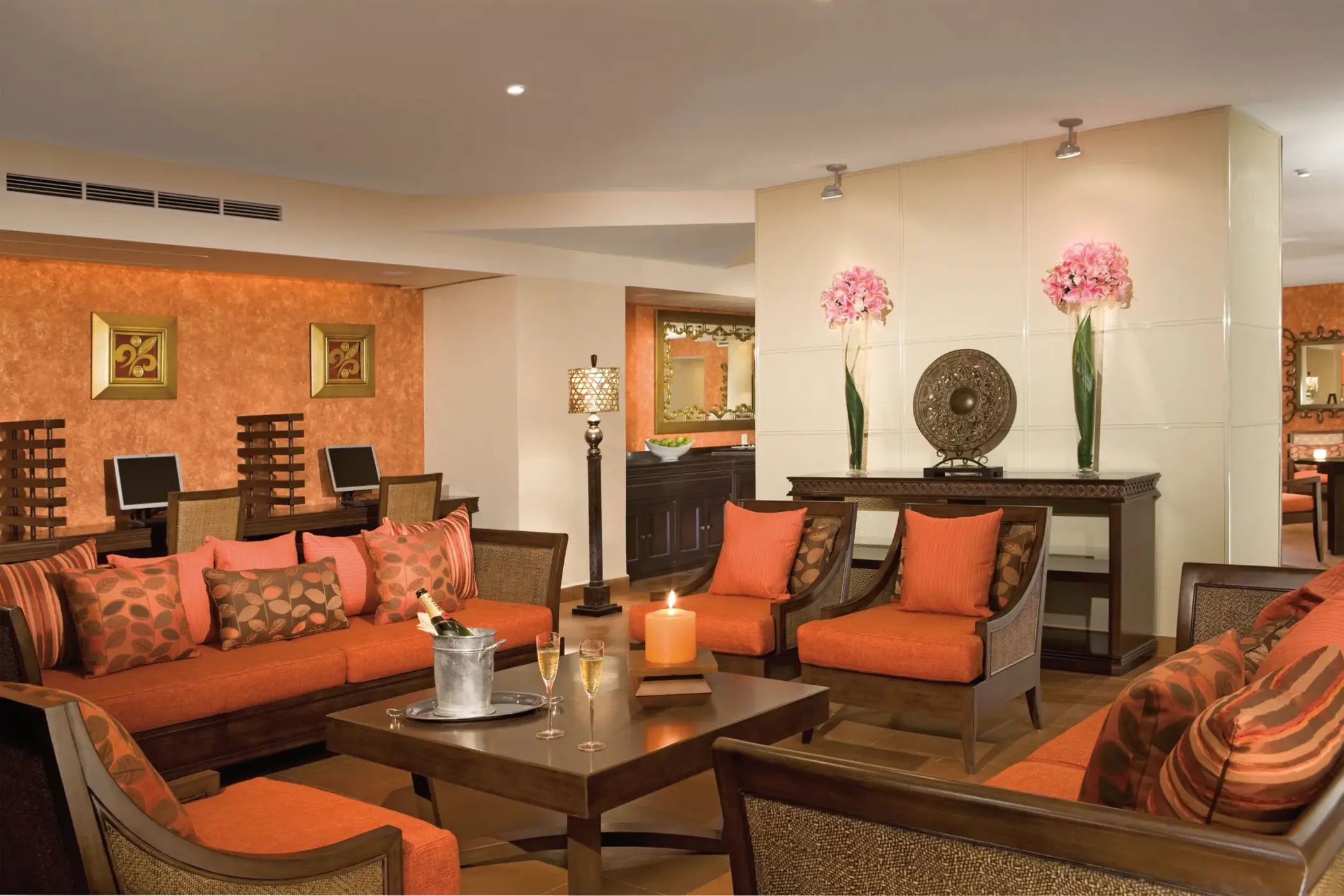 Preferred Club lounge interior with plush orange seating and a cozy ambiance.