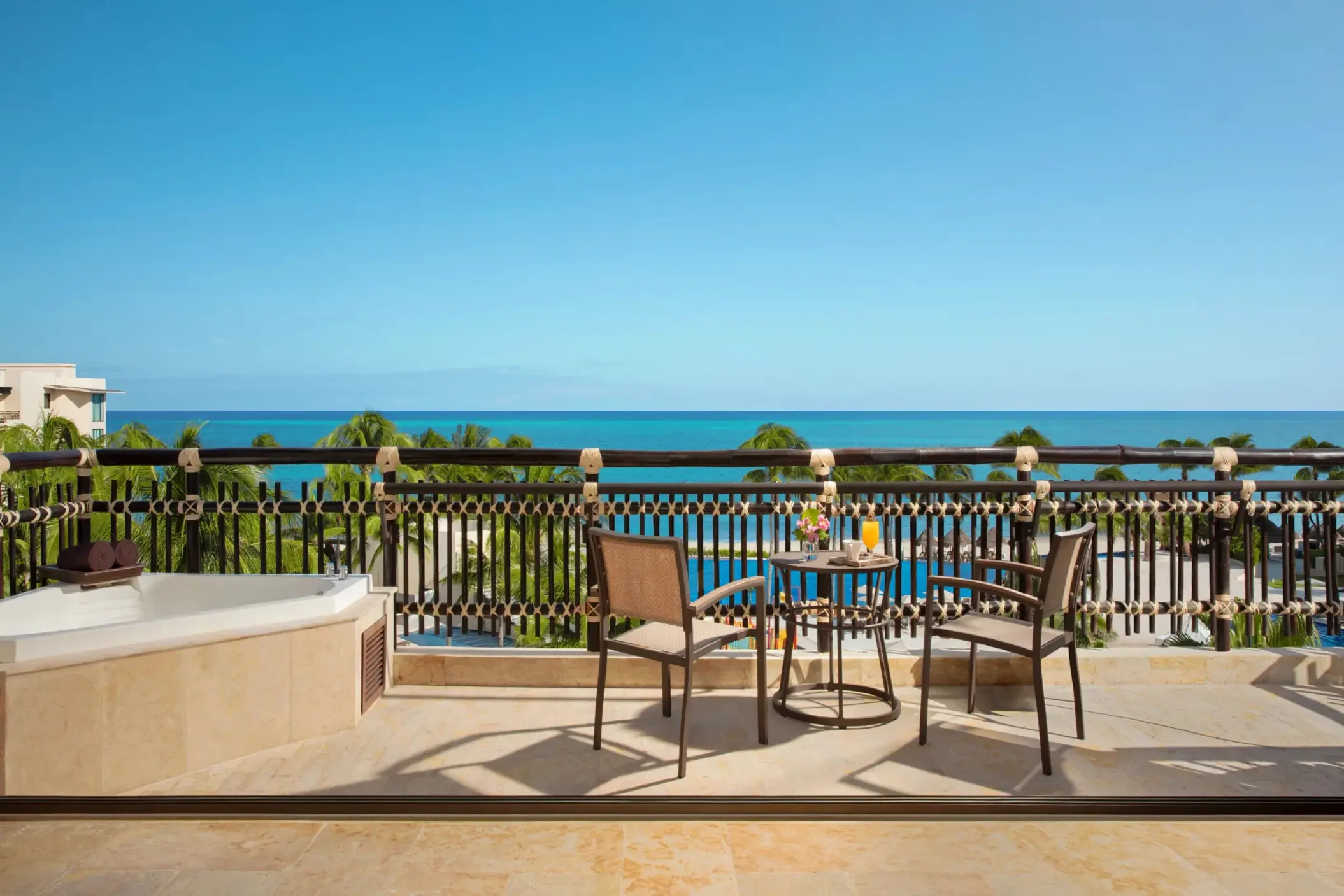 Terrace view with Jacuzzi tub and ocean backdrop from the Ocean Pool Front Suite.