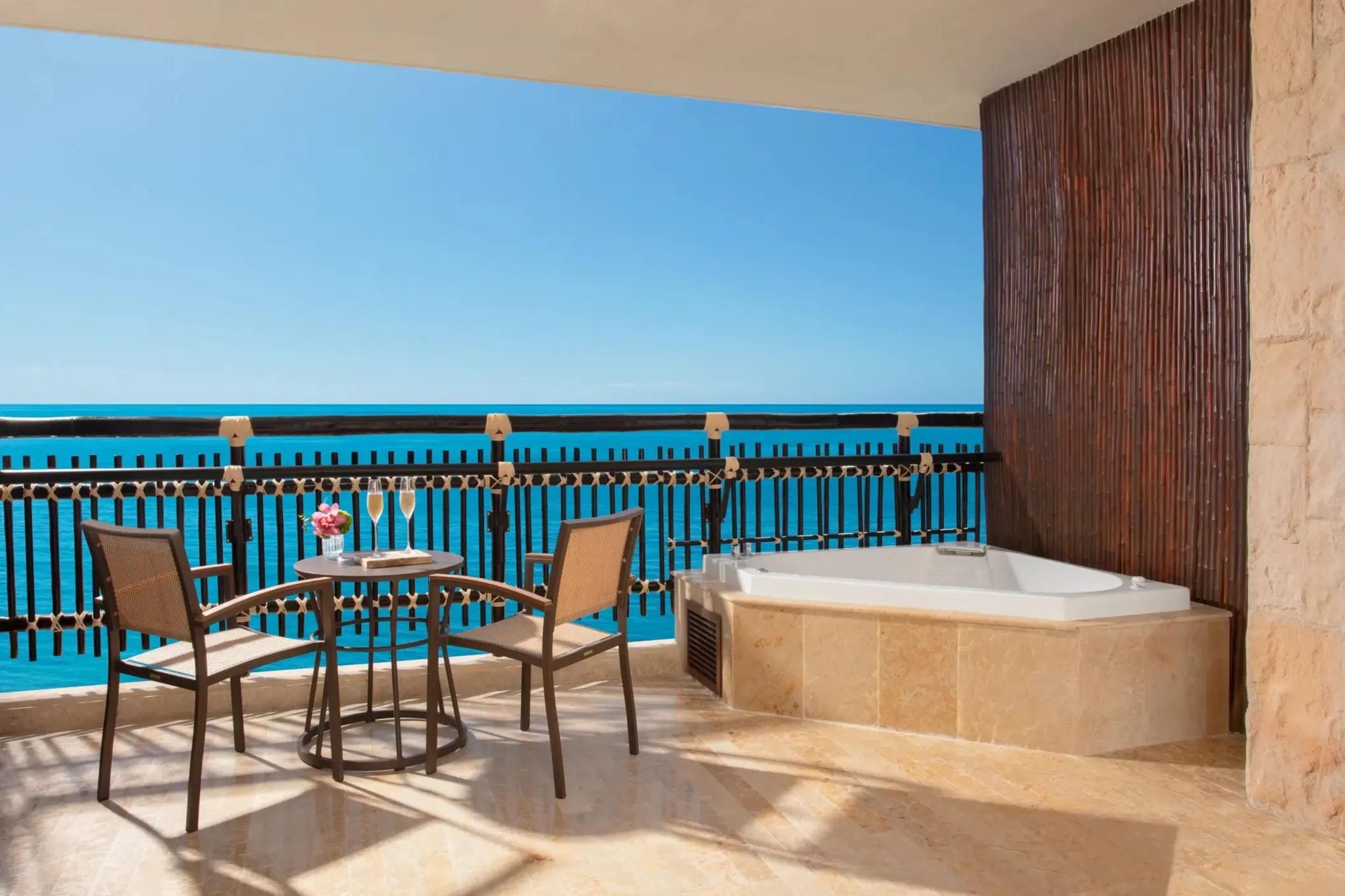 Private terrace with oceanview Jacuzzi and two-chair breakfast table in Honeymoon Suite.