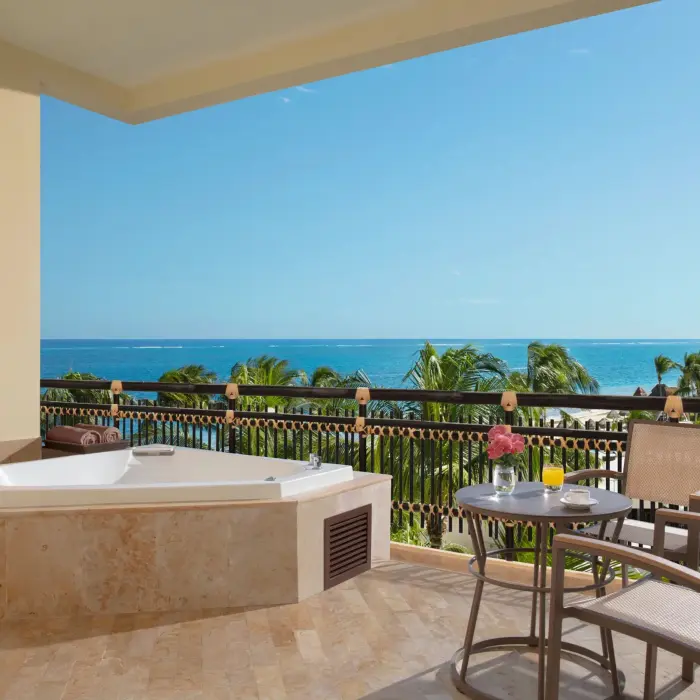 Ocean view terrace with seating and Jacuzzi overlooking the Caribbean Sea.