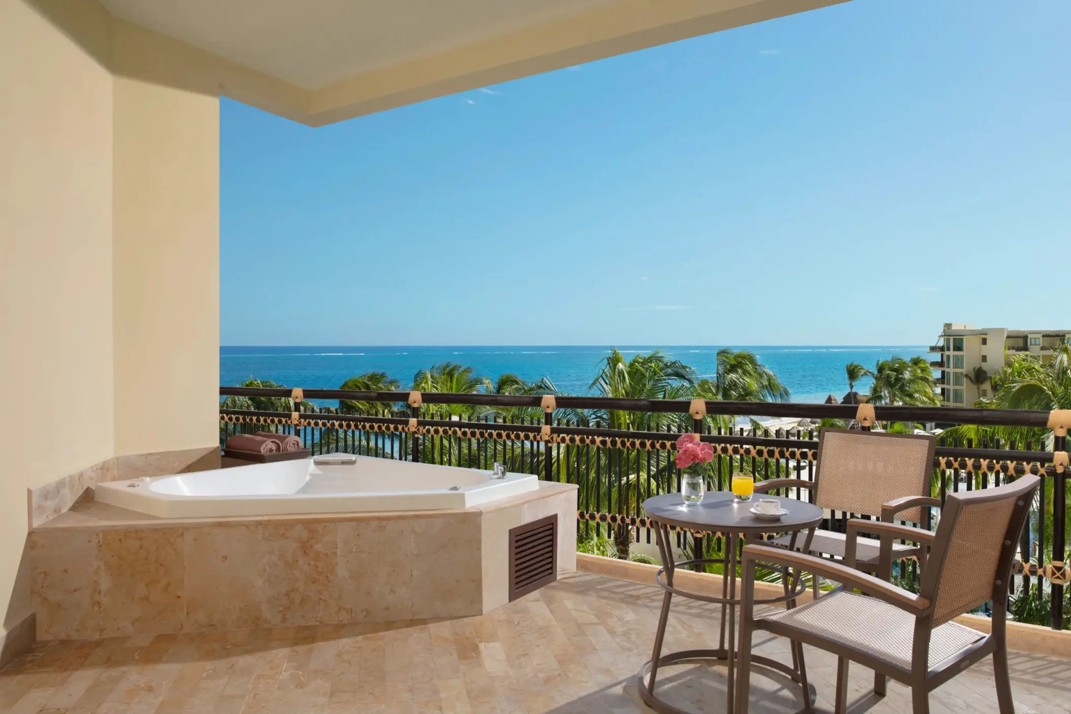 Ocean view terrace with seating and Jacuzzi overlooking the Caribbean Sea.