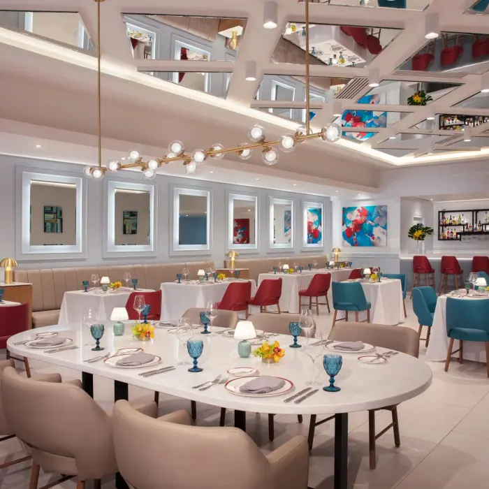 Modern Italian dining room at Portofino in Dreams Riviera Cancun featuring colorful accents and chic design.