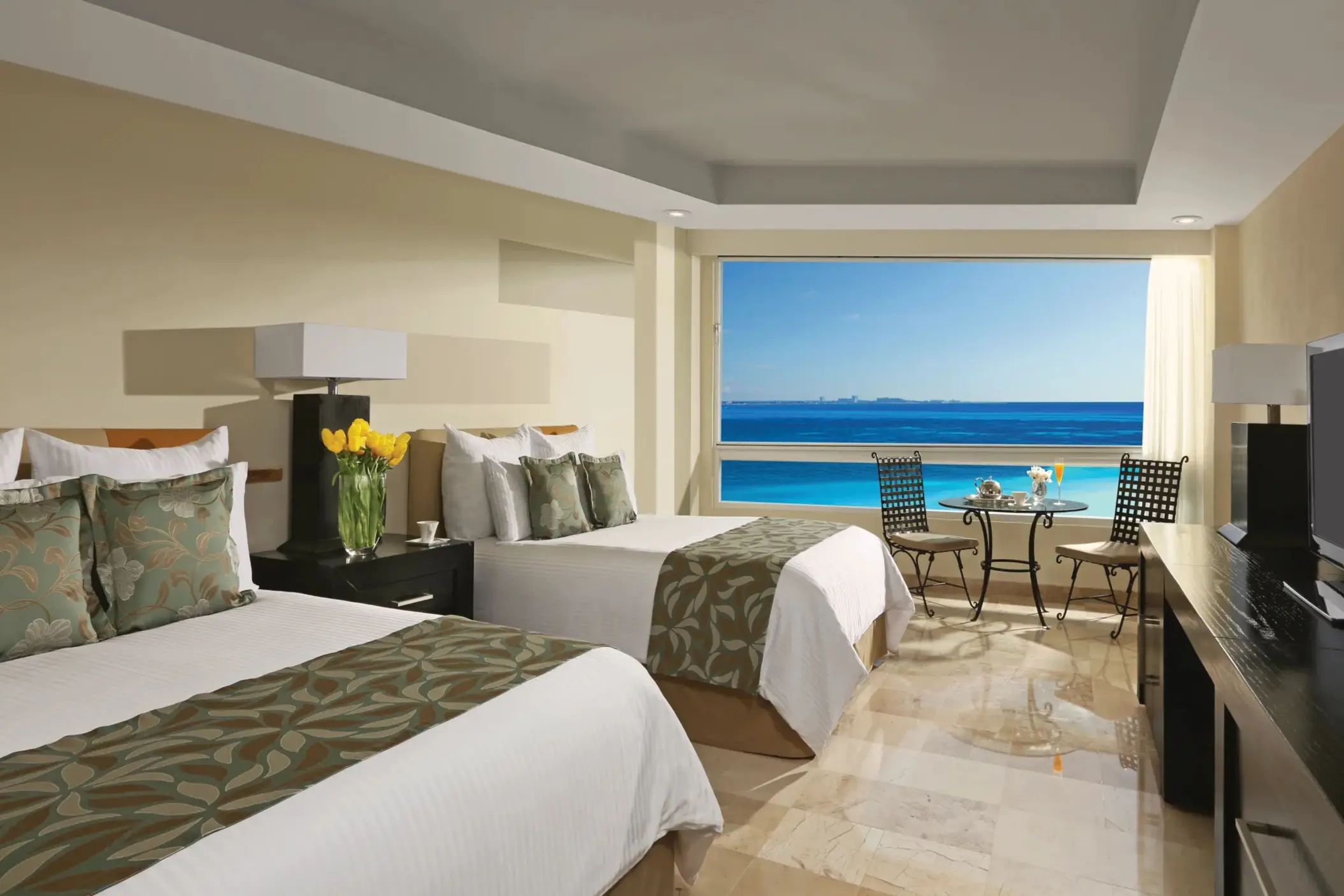 Double oceanfront room with two beds, tropical decor, and breathtaking Caribbean views.