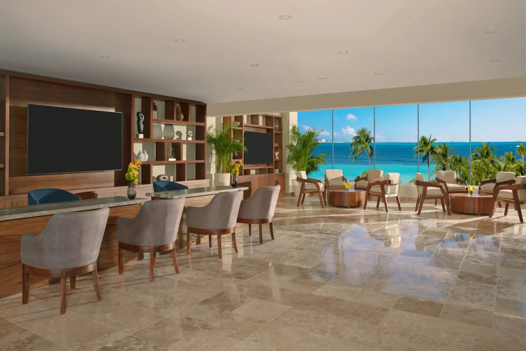 Elegant resort lounge with ocean views, comfortable seating, and warm wood accents in a relaxed setting.