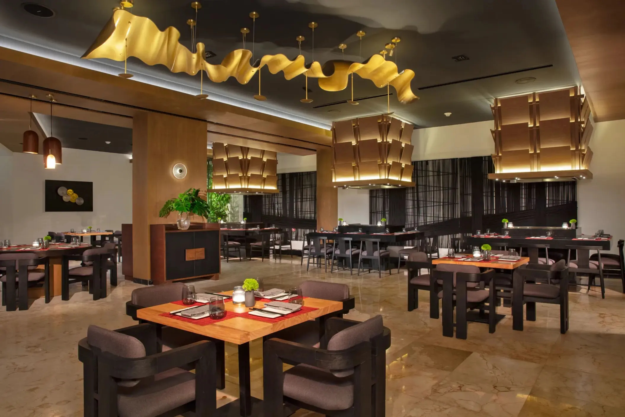 Sophisticated Himitsu dining area with stylish lighting, wood accents, and contemporary seating.
