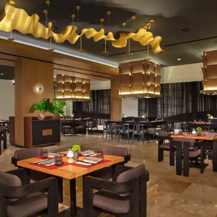 Sophisticated Himitsu dining area with stylish lighting, wood accents, and contemporary seating.