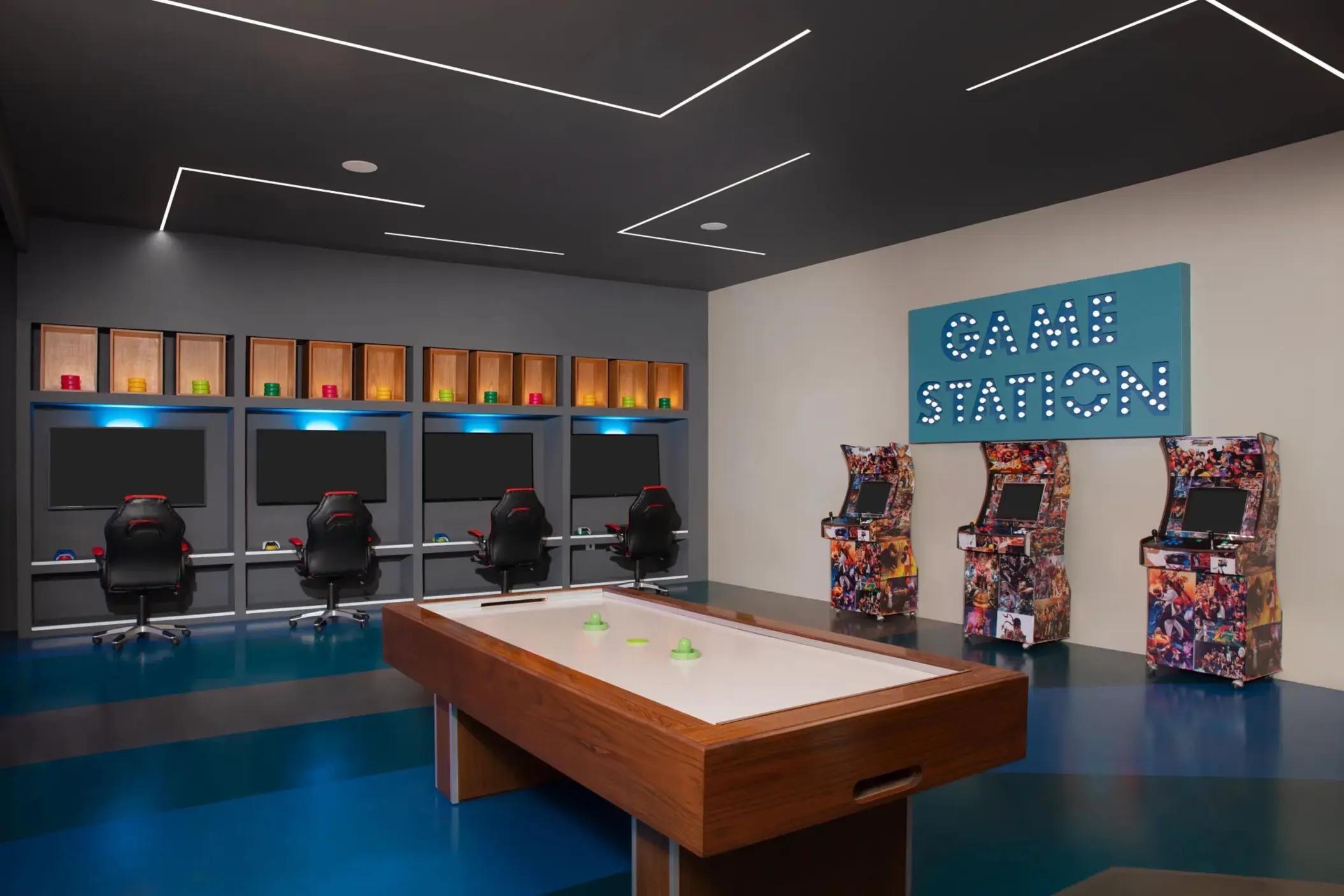 Game room featuring arcade machines, air hockey, and gaming stations with LED lighting and modern decor.