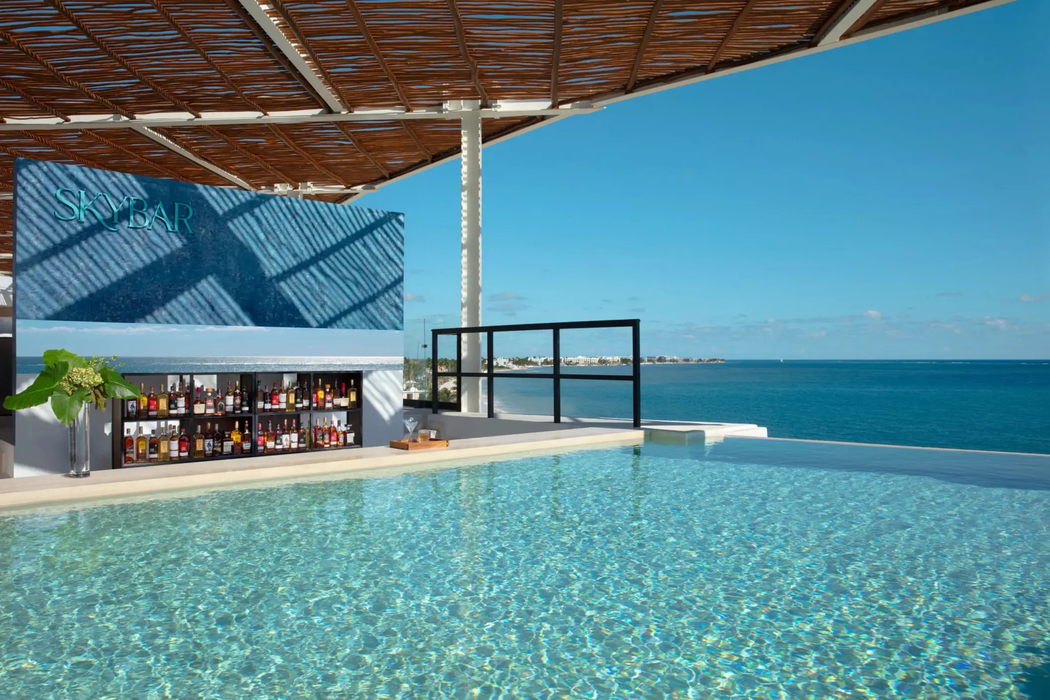 Rooftop SkyBar with ocean views and craft cocktails at Dreams Sapphire Resort & Spa, the perfect sunset hangout.