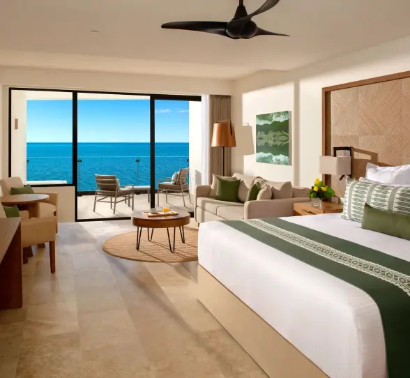 Spacious Junior Suite with plush king bed and stunning oceanfront views.