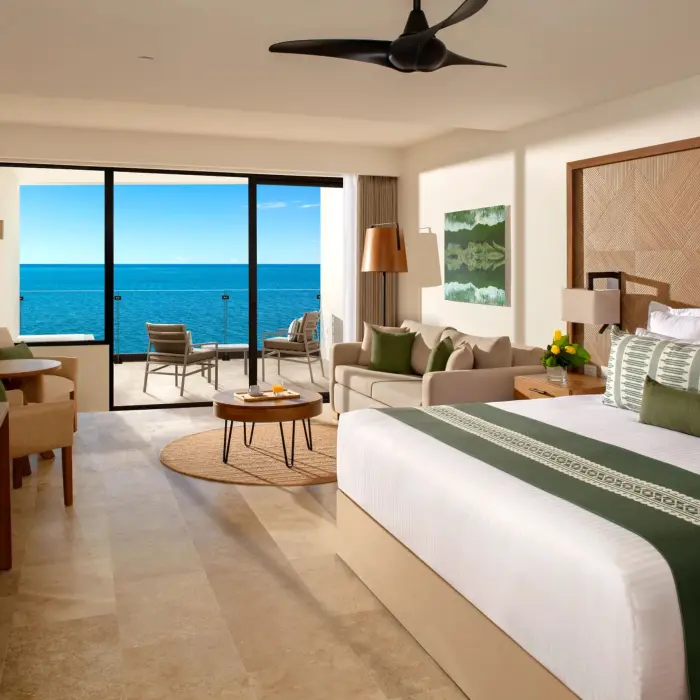 Spacious Junior Suite with plush king bed and stunning oceanfront views.