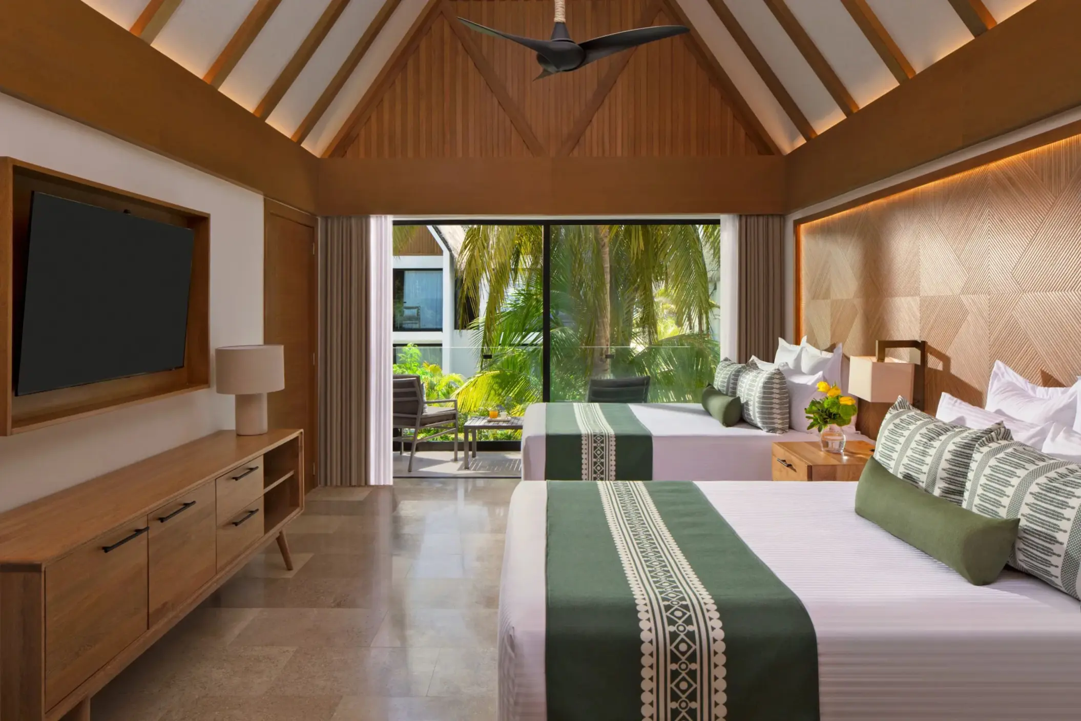 Charming private villa room with double beds, ideal for family getaways.