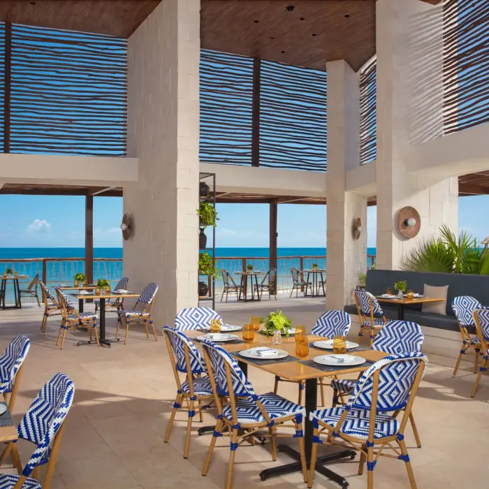 Beachside dining at Bluewater Grill with ocean breezes, fresh seafood, and a relaxed coastal vibe at Dreams Sapphire Resort.
