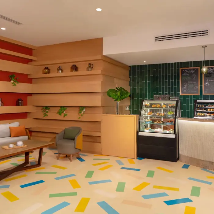 Cozy and modern Coco Café, serving premium coffee, pastries, and grab-and-go treats in a laid-back lounge setting.