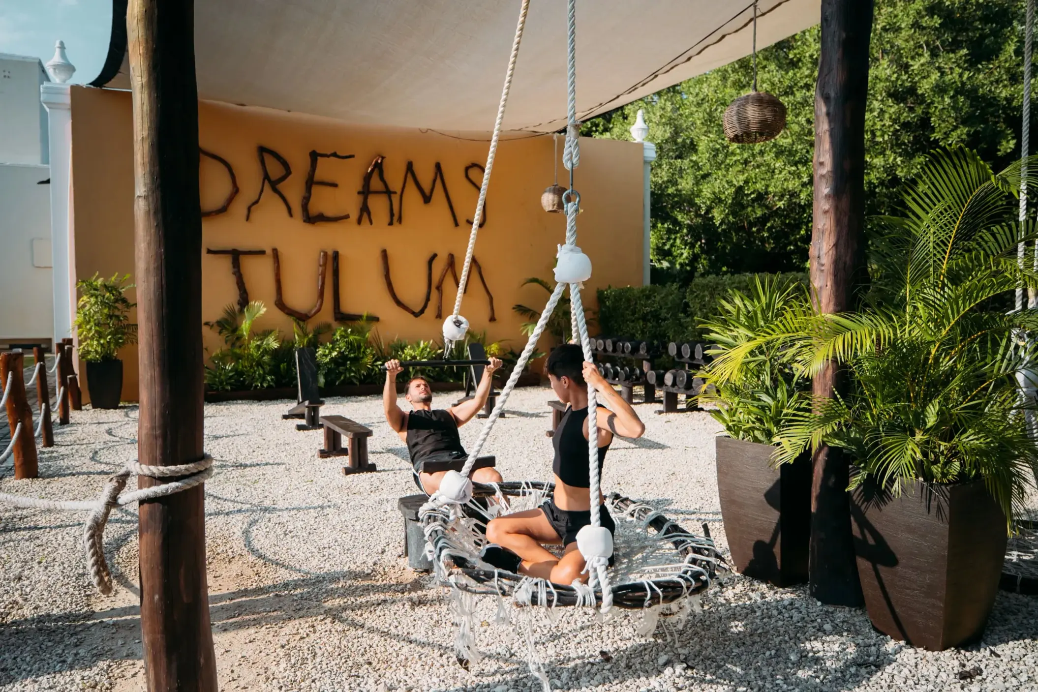 Outdoor fitness area at Dreams Tulum with natural wooden decor, rope equipment, and open-air training zones.