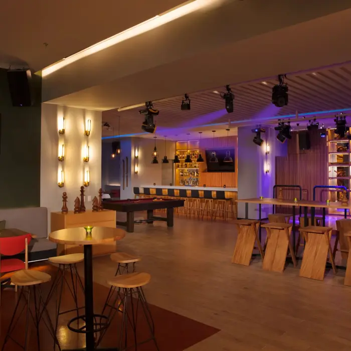 Desires Bar and Lounge with dance floor, modern lighting, high tables, and billiards area.