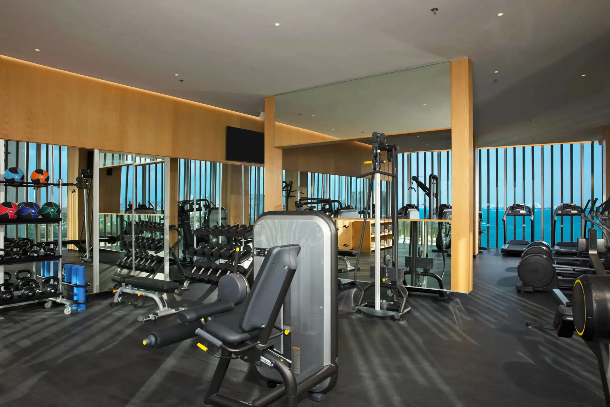 Modern fitness center at Dreams Vista Cancun featuring cardio and strength equipment with sea views.