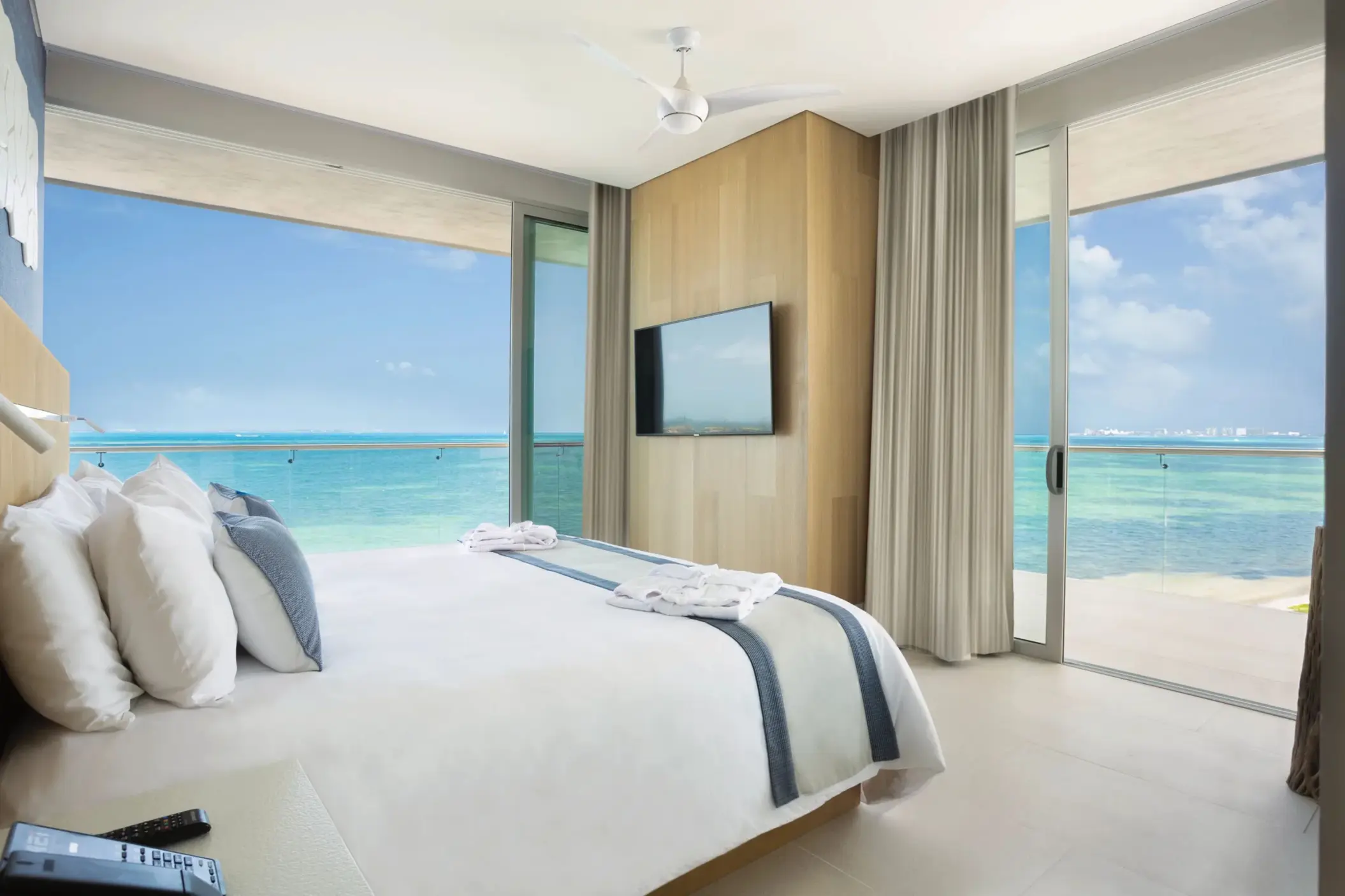 Master one-bedroom suite with king bed and floor-to-ceiling ocean view windows at Dreams Vista Cancun.