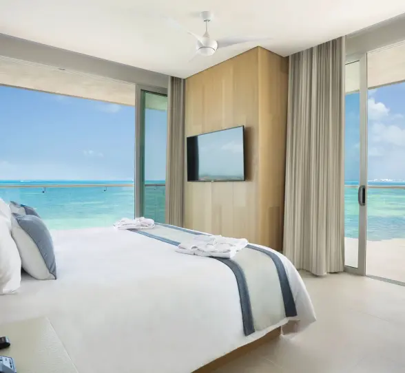 Master one-bedroom suite with king bed and floor-to-ceiling ocean view windows at Dreams Vista Cancun.