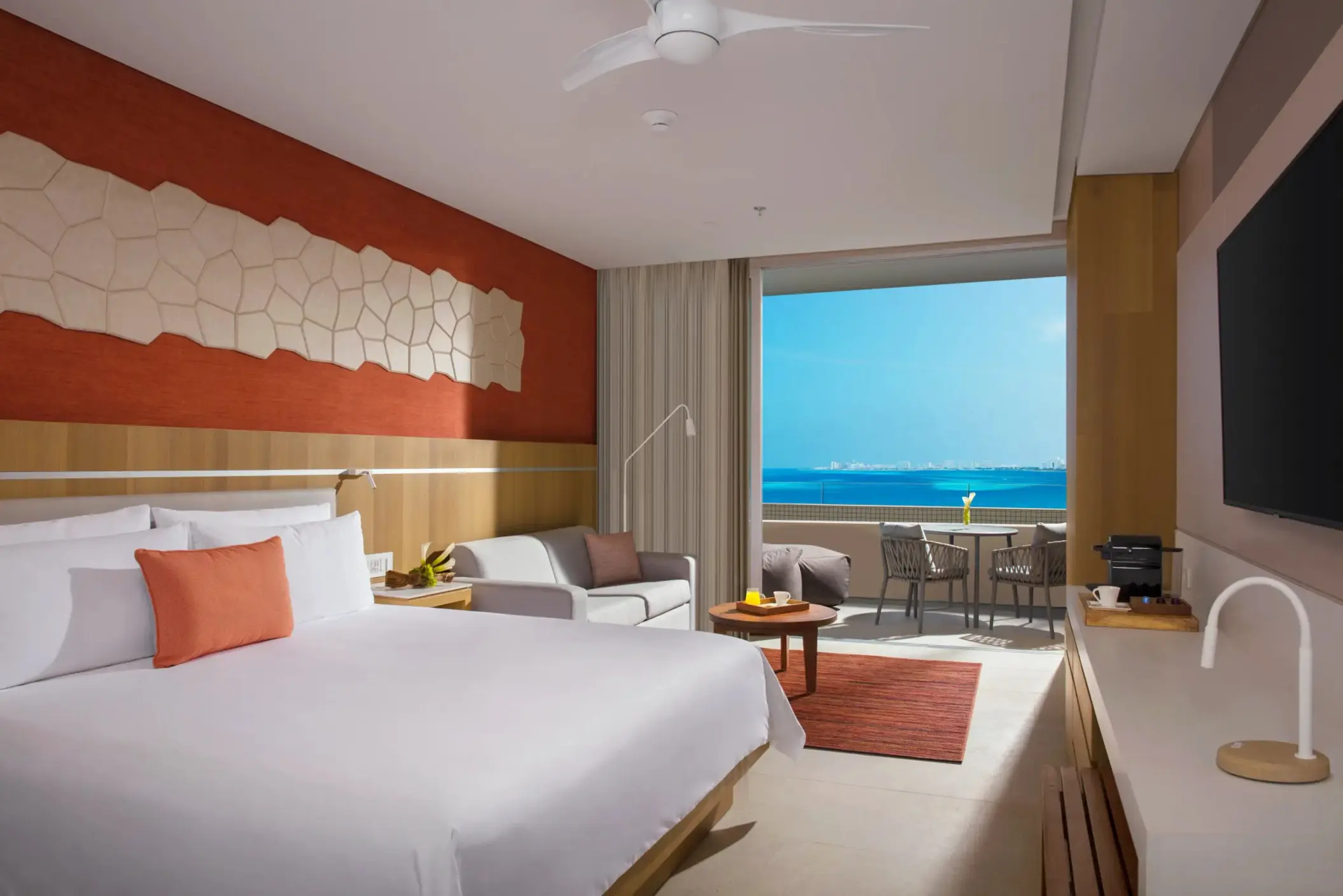Modern room with private plunge pool and golf course view, featuring cozy seating and sunlit patio space.