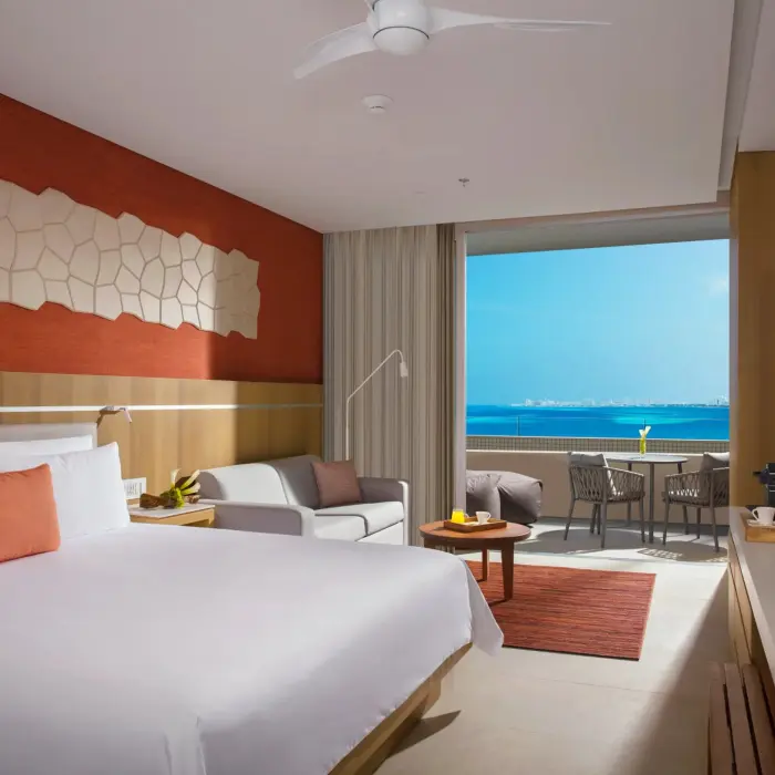 Modern room with private plunge pool and golf course view, featuring cozy seating and sunlit patio space.