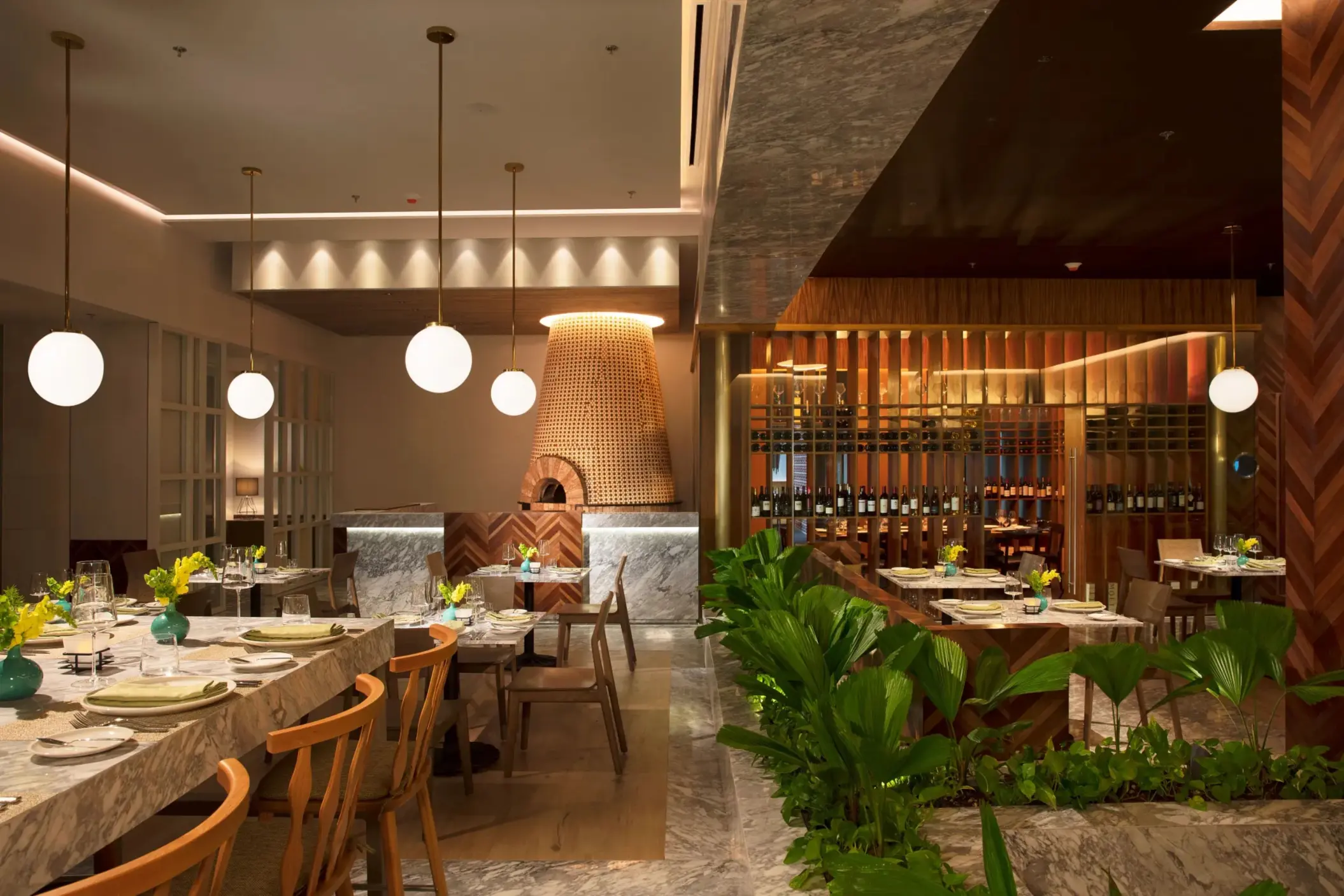 Elegant Italian dining at Portofino with marble accents, wine display, and soft lighting.