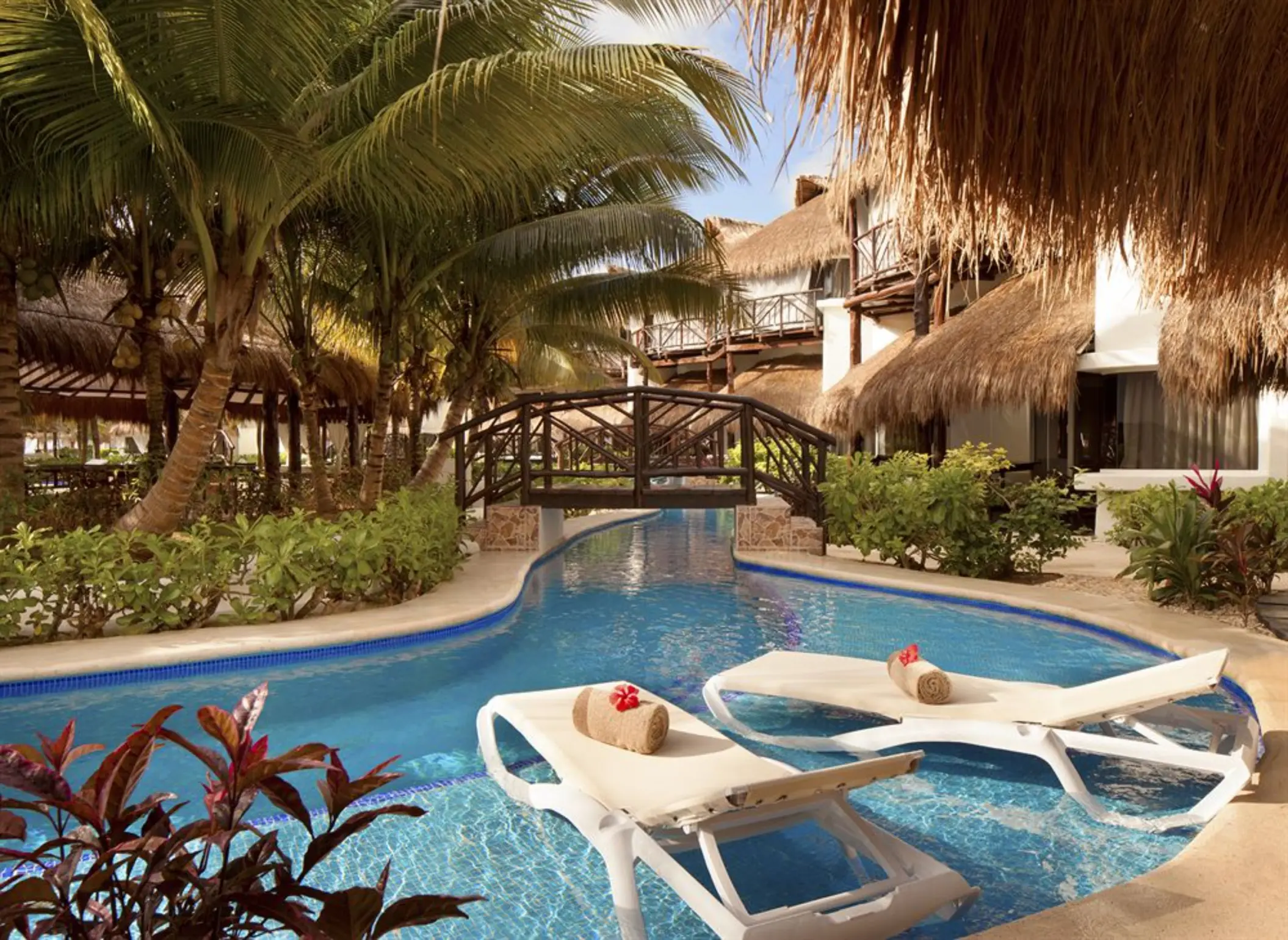 bridge over the pool and loungers at El Dorado Casitas Royale