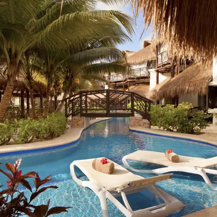 bridge over the pool and loungers at El Dorado Casitas Royale