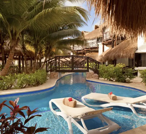 bridge over the pool and loungers at El Dorado Casitas Royale
