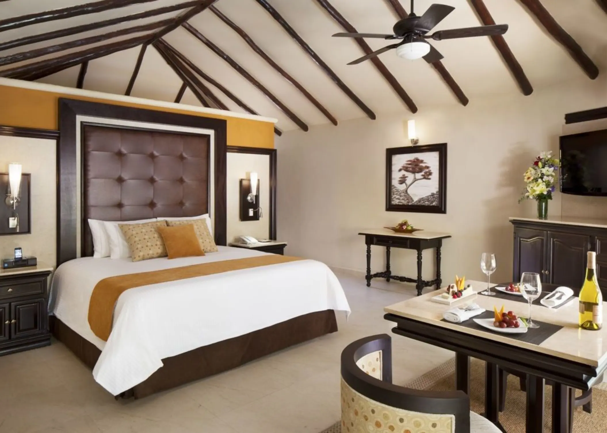 casita at El Dorado Casitas Royale with comfortable bed and a table with fruits and bubbly