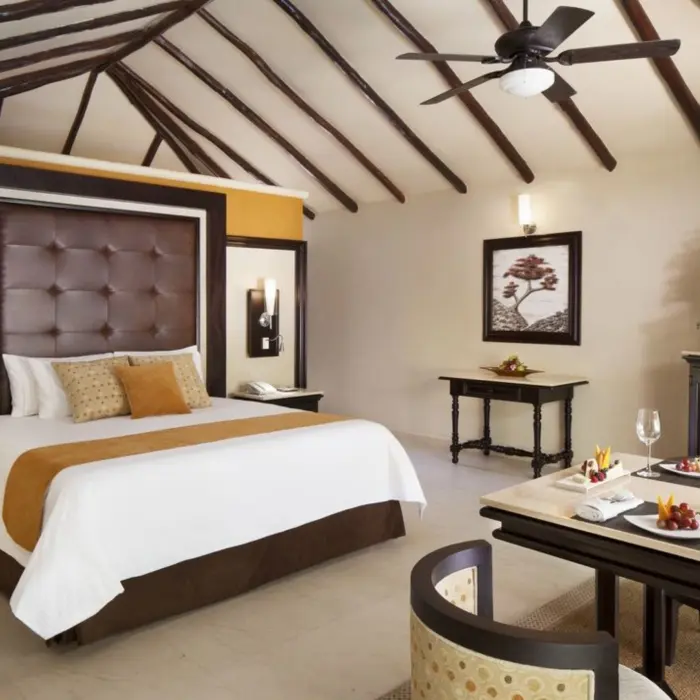 casita at El Dorado Casitas Royale with comfortable bed and a table with fruits and bubbly