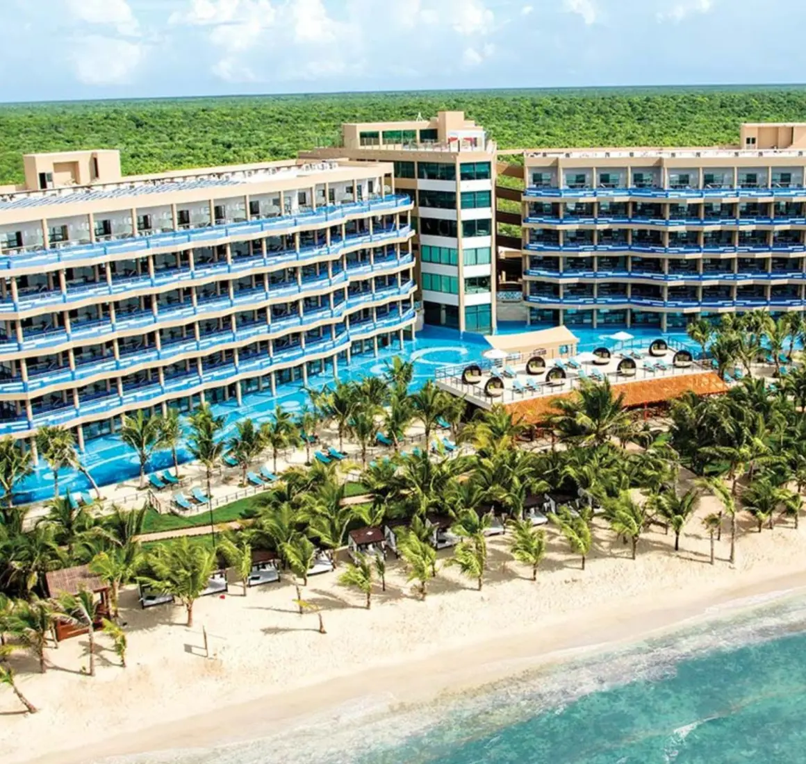exterior view of El Dorado Seaside Suites with its buildings and pools and beach