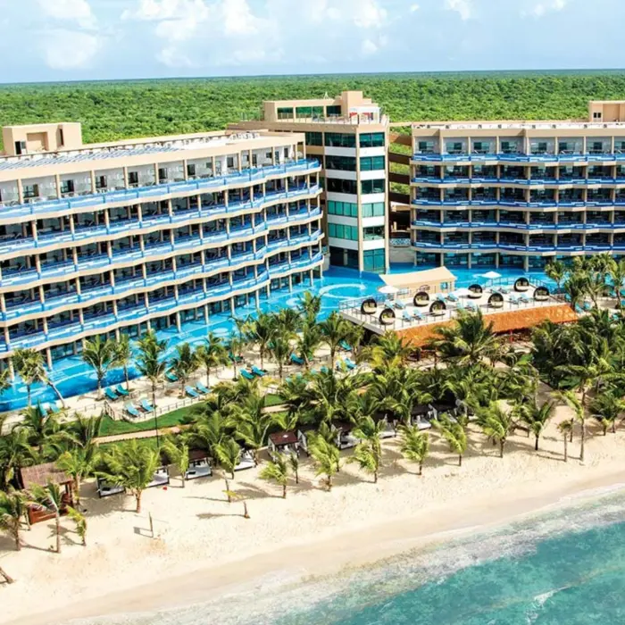 exterior view of El Dorado Seaside Suites with its buildings and pools and beach