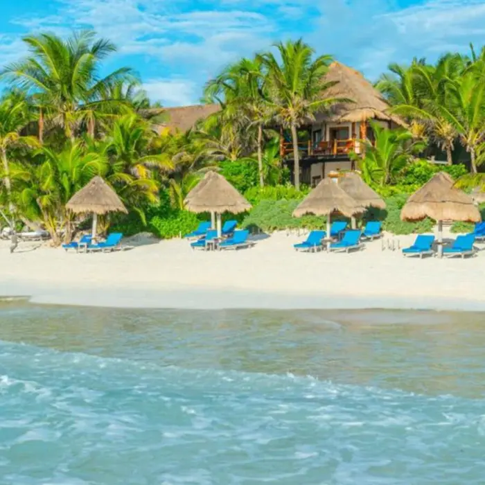 beach and loungers and resort buildings at Encantada Tulum