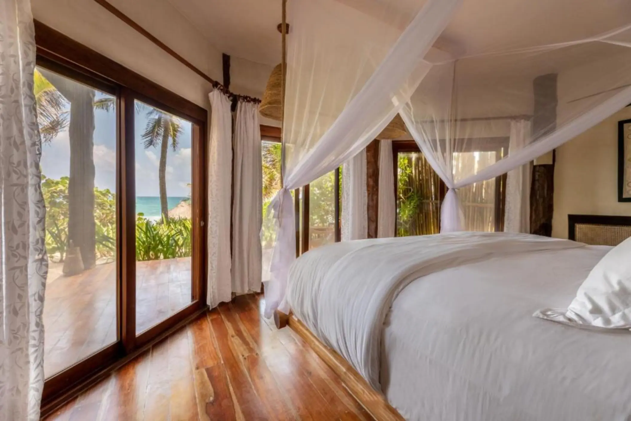 beach front lower room with bed and wooden flooring at Encantada Tulum