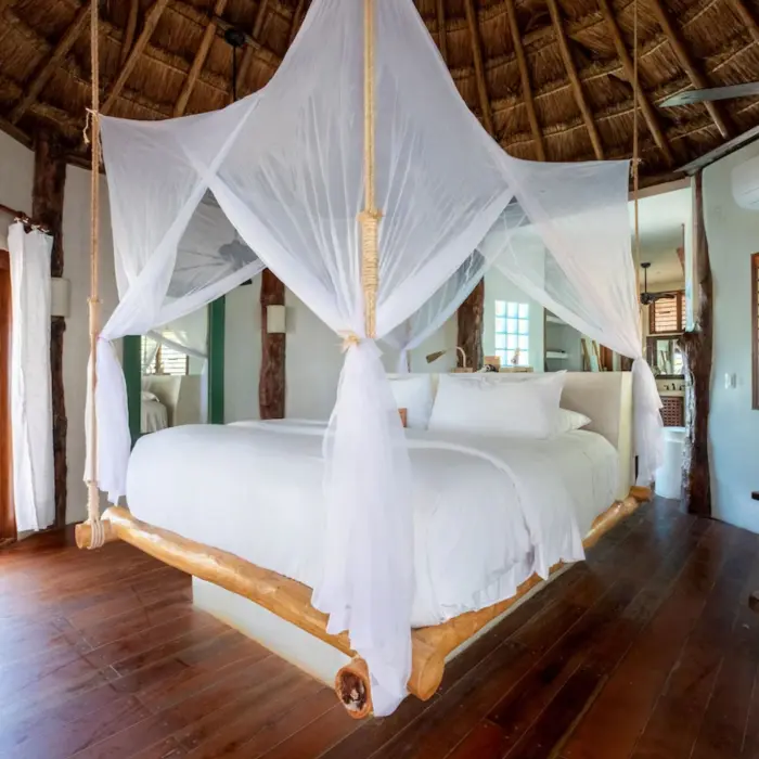 suite with wooden accents and rustic decor at Encantada Tulum