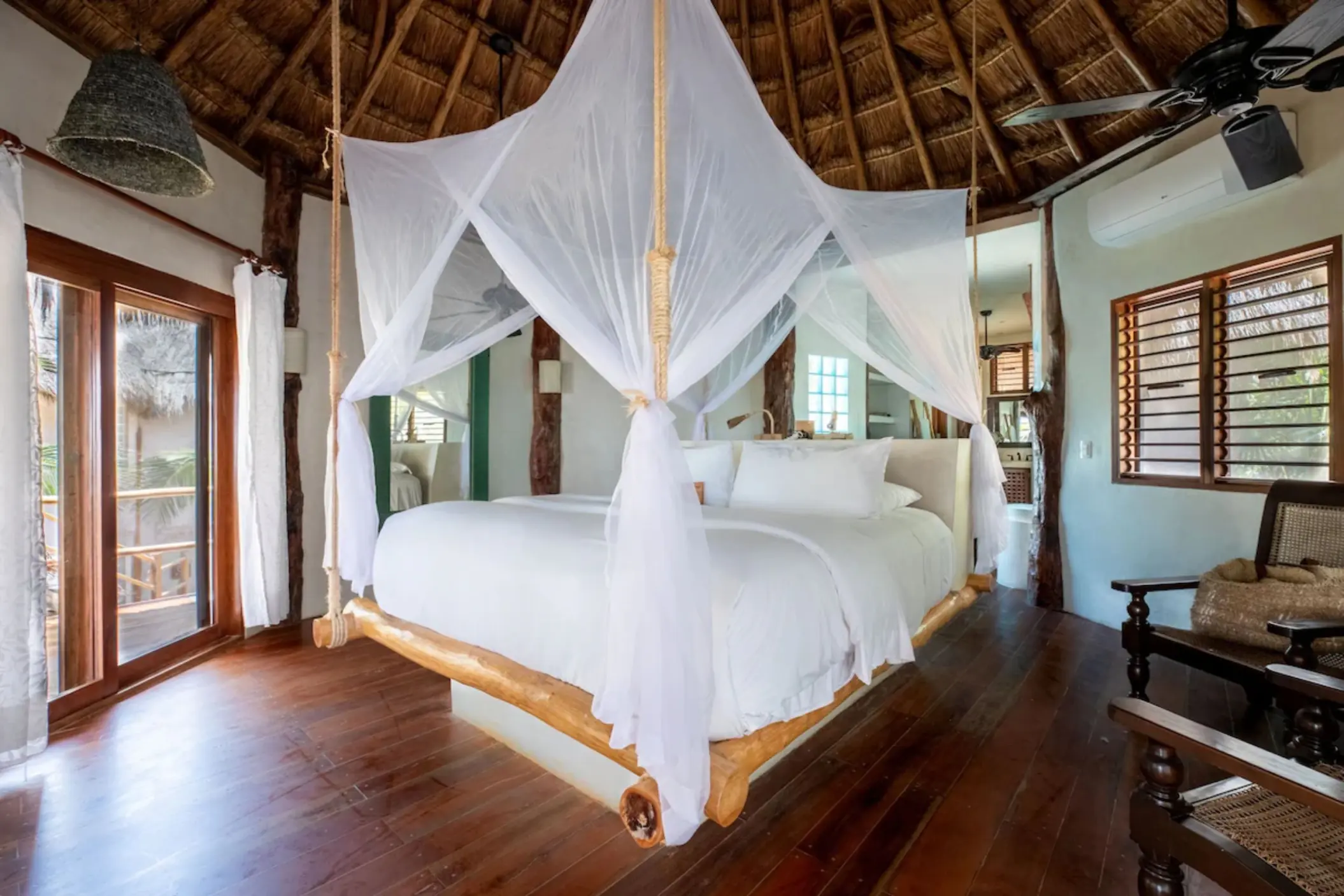 suite with wooden accents and rustic decor at Encantada Tulum