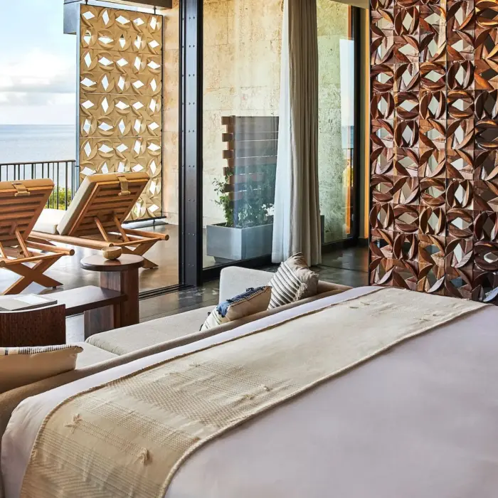 suite at Etereo Riviera Maya with king bed and sea views and furnished balcony