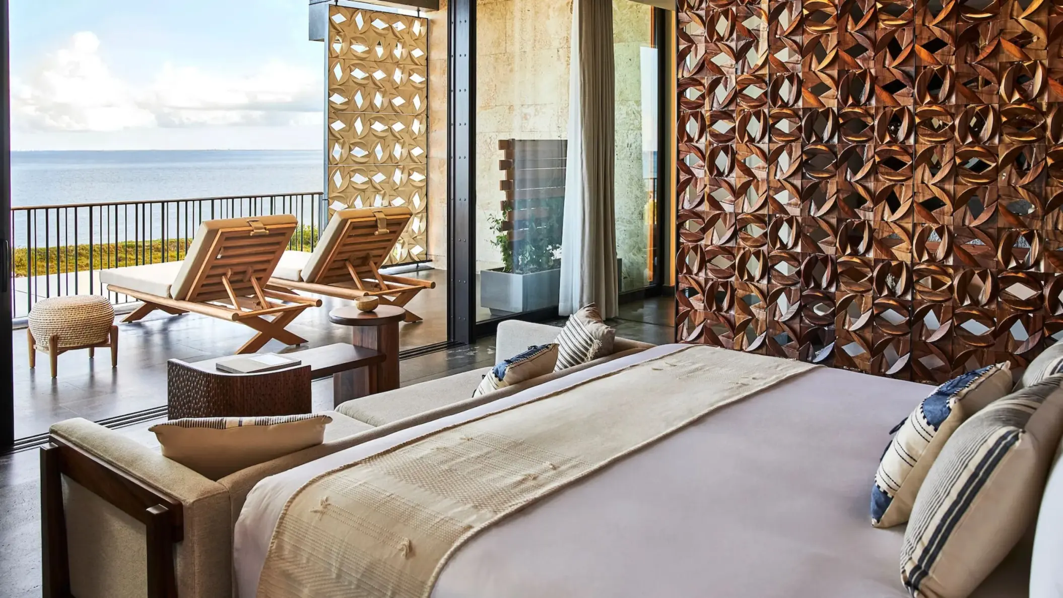 suite at Etereo Riviera Maya with king bed and sea views and furnished balcony