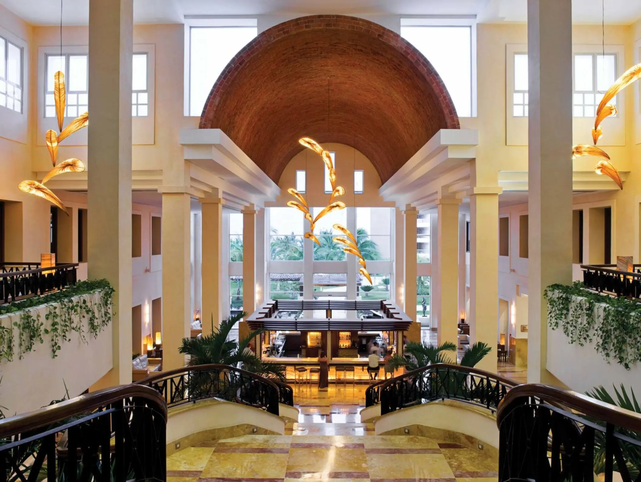 Stylish lobby bar with dramatic lighting and elegant architecture at Excellence Playa Mujeres in Cancun.
